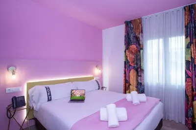 a bedroom with two beds and a laptop on top of them at Casual Colours Barcelona in Barcelona