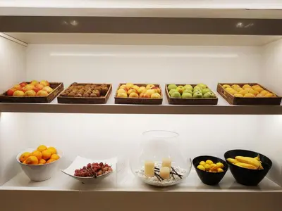 a shelf filled with bowls of fruits and vegetables at Hotel Bernat II 4*Sup in Calella
