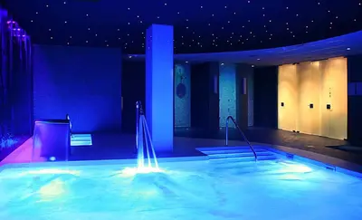 a large swimming pool with a fountain in a building at Hotel Bernat II 4*Sup in Calella