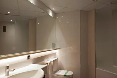 a bathroom with a sink and a toilet and a mirror at Hotel Bernat II 4*Sup in Calella