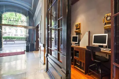 a room with two computer monitors on a desk at Acta Atrium Palace in Barcelona