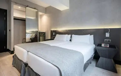 a large white bed in a hotel room at Ilunion Bel-Art in Barcelona