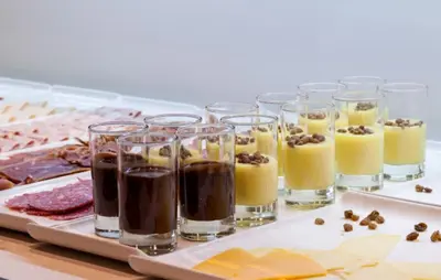 a group of glasses of coffee and food on a table at Ilunion Bel-Art in Barcelona