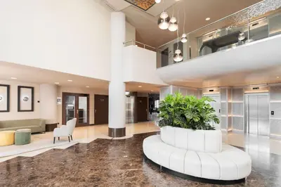 a lobby with a large plant in the middle at Hotel Alimara in Barcelona