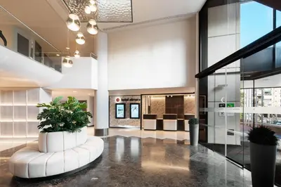 a lobby of a building with a plant in the middle at Hotel Alimara in Barcelona