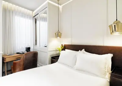 a hotel room with a bed and a desk and a chair at Boutique Hotel H10 Montcada in Barcelona