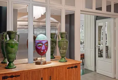 a display of vases and a mask on a table at Boutique Hotel H10 Montcada in Barcelona