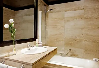 a bathroom with a sink and a bath tub at Boutique Hotel H10 Montcada in Barcelona