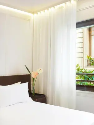 a bedroom with a white bed and a window at Boutique Hotel H10 Montcada in Barcelona