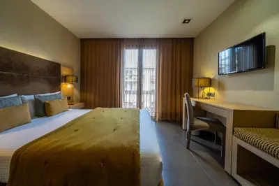 a hotel room with a bed and a desk at Hotel Constanza in Barcelona