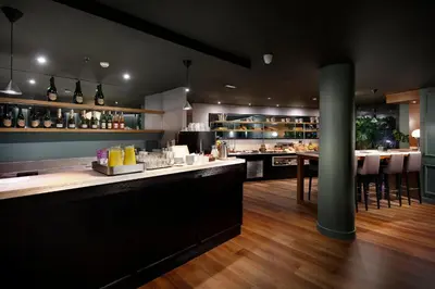 a restaurant with a bar with tables and chairs at Wilson Boutique Hotel in Barcelona