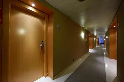 a corridor of a hallway with doors and a long hallway at Attica 21 Barcelona Mar in Barcelona