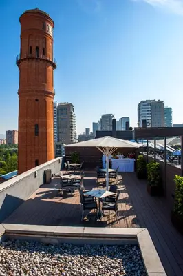 a lighthouse on top of a building with tables and chairs at Attica 21 Barcelona Mar in Barcelona