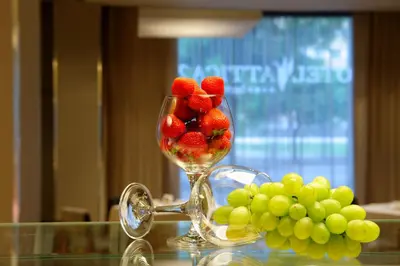 a glass vase filled with strawberries and grapes on a table at Attica 21 Barcelona Mar in Barcelona