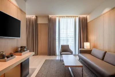 a living room with a couch and a large window at AC Hotel Diagonal L'Illa by Marriott in Barcelona