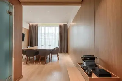 a kitchen and dining room with a table and chairs at AC Hotel Diagonal L'Illa by Marriott in Barcelona