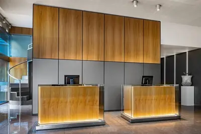 a lobby with two reception desks and wooden walls at AC Hotel Diagonal L'Illa by Marriott in Barcelona