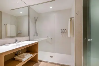 a bathroom with a sink and a shower at AC Hotel Diagonal L'Illa by Marriott in Barcelona