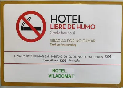 a sign for a hotel with a no smoking sign at Hotel Viladomat in Barcelona