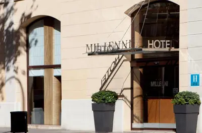 a hotel with two potted plants in front of a building at Garbi Millenni in Barcelona