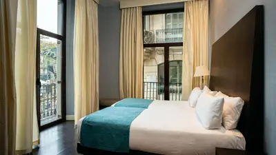a hotel room with a bed and a large window at Hotel Ramblas Internacional in Barcelona