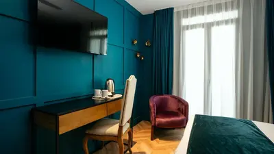 a room with a desk and a bed and a window at Hotel Ramblas Internacional in Barcelona