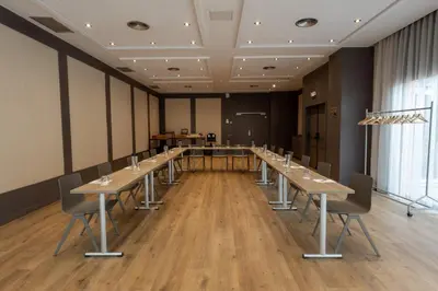 a conference room with long tables and chairs at Abba Garden in Barcelona
