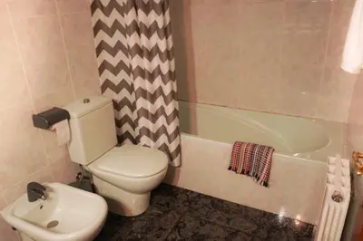 a bathroom with a toilet and a bath tub at Habitación doble con Balcón - Casa rural compartida - Coliving in Torrellas de Foix