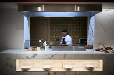 a man standing in a kitchen preparing food at Catalonia Plaza Catalunya in Barcelona