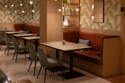 a row of tables and chairs in a restaurant at Catalonia Diagonal Centro in Barcelona