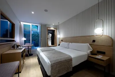 a hotel room with a large bed and a window at Catalonia Diagonal Centro in Barcelona