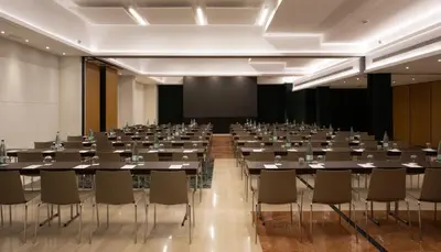 a large room with tables and chairs in it at Catalonia Diagonal Centro in Barcelona