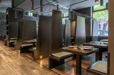 a table with a plate of meat and a glass of wine at Catalonia Barcelona Plaza in Barcelona