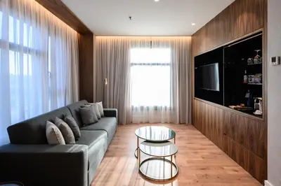 a living room with a couch and a table at Catalonia Barcelona Plaza in Barcelona