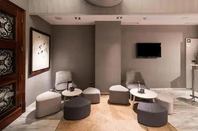a waiting room with two tables and two chairs at Catalonia Gracia in Barcelona