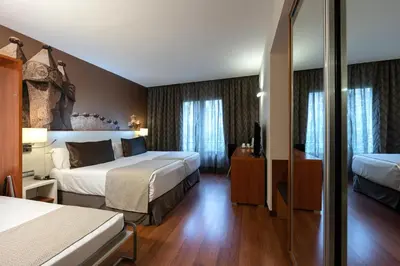 a hotel room with a bed and a desk at Catalonia Gracia in Barcelona