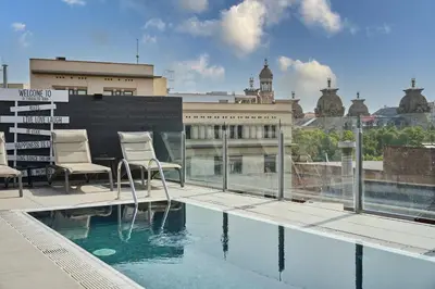 a hotel room with a bed and a picture of a city at Catalonia Born in Barcelona