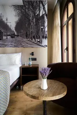 a room with a bed and a coffee table with a bed and a couch at Catalonia Born in Barcelona