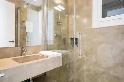a bathroom with a sink and a shower at Sitges Group Ocean in Sitges