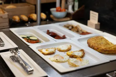 a loaf of bread on a cutting board with a knife at Catalonia Albeniz in Barcelona