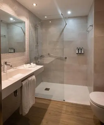 a bedroom with a bed and a desk and a chair at Catalonia Albeniz in Barcelona