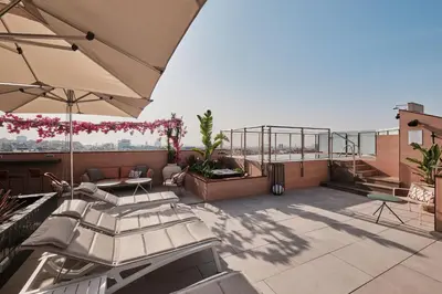 a rooftop patio with a view of the city at Catalonia Park Putxet in Barcelona