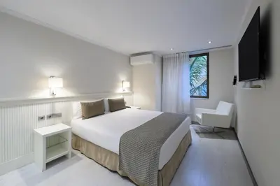 a hotel room with a bed and a television at Catalonia Roma in Barcelona