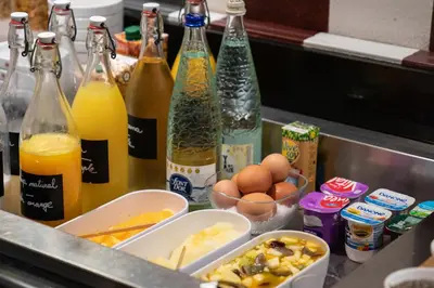 a kitchen counter with bottles of drinks and eggs at Catalonia Roma in Barcelona