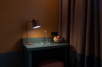 a table with glasses and a lamp and a bowl of fruit at chic&basic Reding in Barcelona