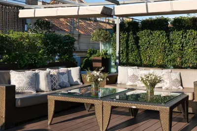 a patio with a table and chairs and plants at Duquesa de Cardona Hotel 4 Sup by Grup Duquessa in Barcelona