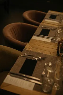 a wooden table with plates and silverware on top of it at Duquesa de Cardona Hotel 4 Sup by Grup Duquessa in Barcelona
