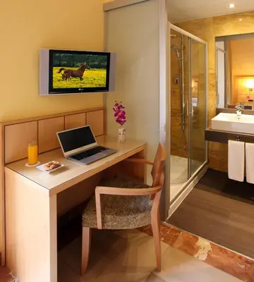 a bathroom with a desk with a laptop on it at Hotel Nouvel in Barcelona