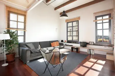 a living room with a couch and a table at Beach Loft Duplex in Barcelona