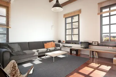 a living room with a couch and a table at Beach Loft Duplex in Barcelona
